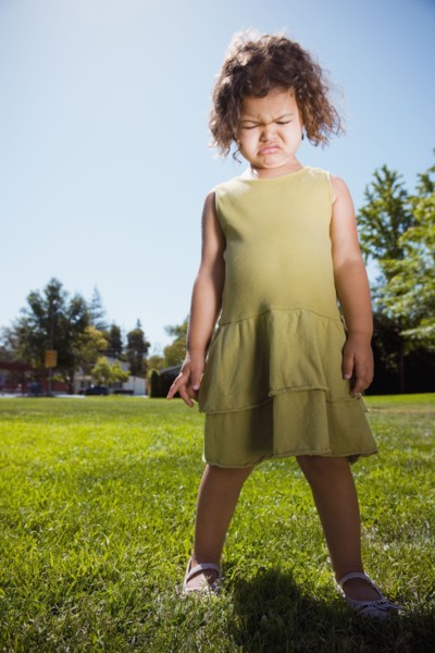 Mixed race girl crying in park