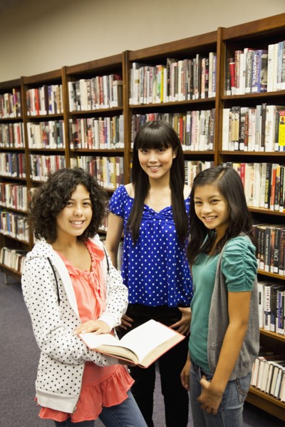 Girls standing in library