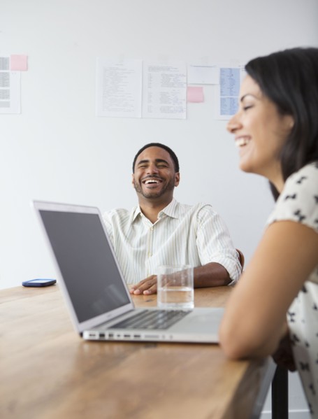 Business people laughing in meeting