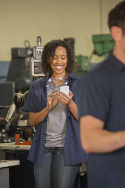 Worker using cell phone in warehouse