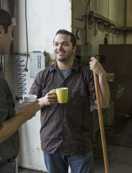 Workers having coffee together in warehouse