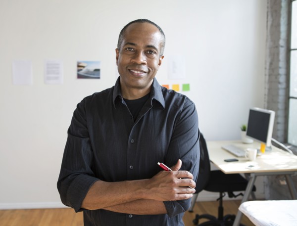 African American architect smiling in office