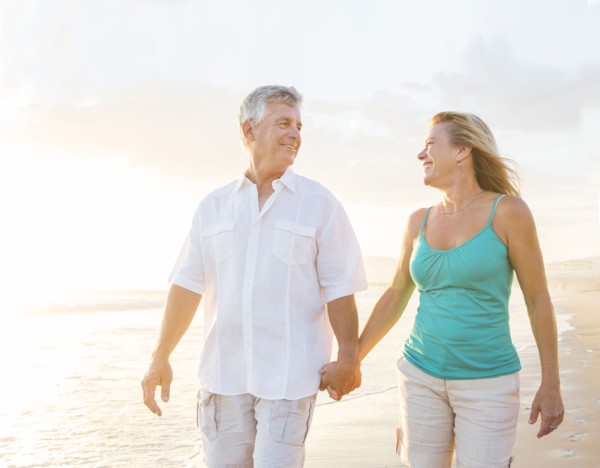 Caucasian couple walking on beach
