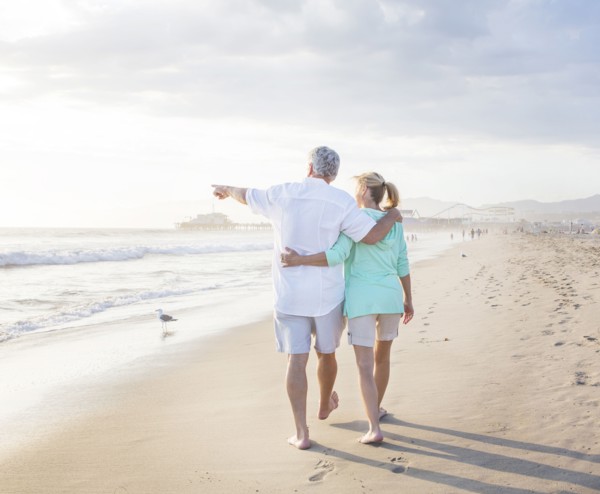 Caucasian couple walking on beach