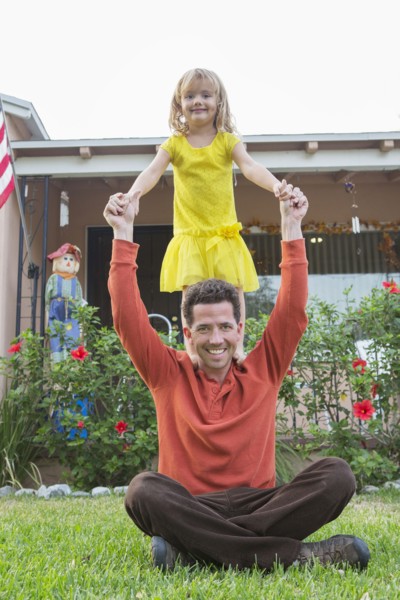 Caucasian father and daughter playing in backyard