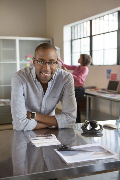 Businessman smiling at desk in office