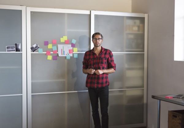 Caucasian businessman standing by cabinet in office