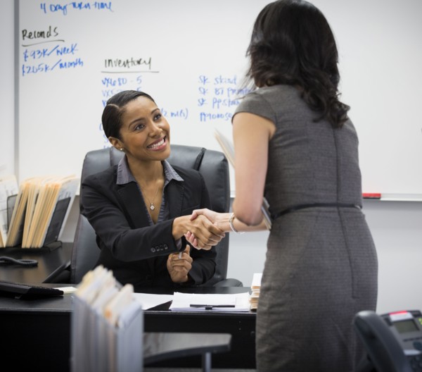 Businesswomen shaking hands in office