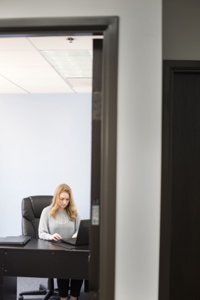 Caucasian businesswoman using laptop in office