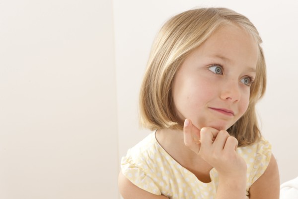 Caucasian girl resting chin in hand