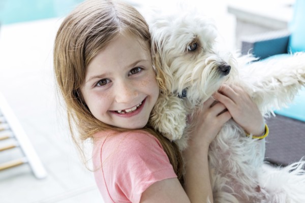 Close up of Caucasian girl hugging puppy