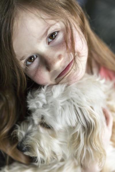 Close up of Caucasian girl hugging puppy