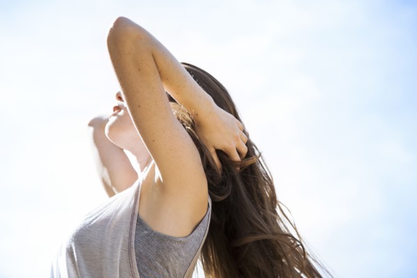 Caucasian woman standing under blue sky
