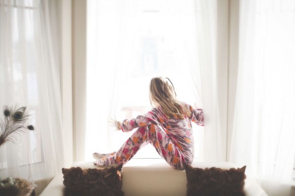 Caucasian girl sitting in window