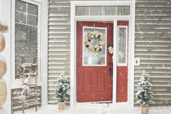 Caucasian woman opening door to snow