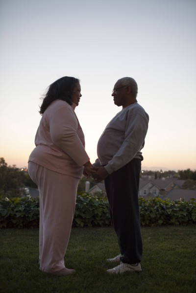 Couple holding hands in backyard