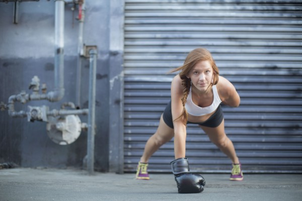 Boxer doing push-ups at warehouse