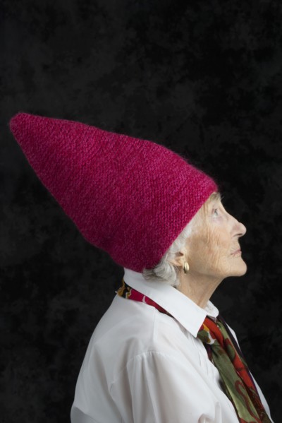 Close up of older woman wearing dunce cap