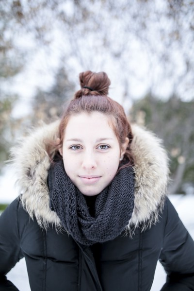 Caucasian teenage girl wearing parka outdoors