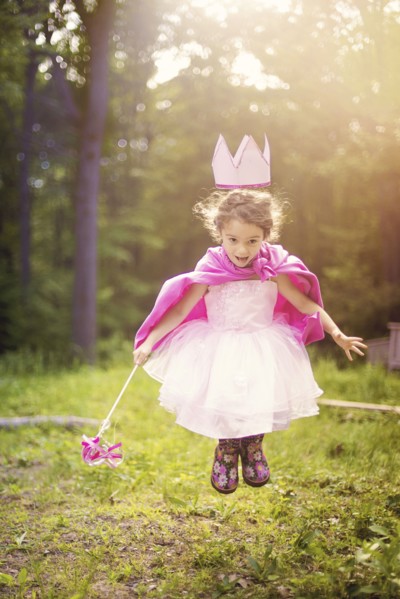Girl playing princess in backyard