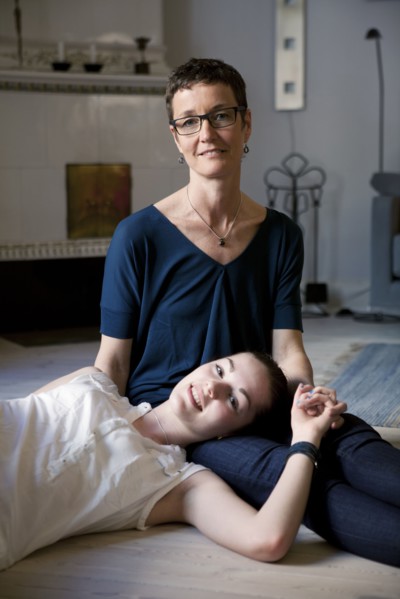 Caucasian mother and daughter hugging on floor