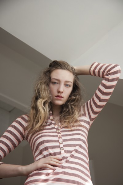 Low angle view of woman posing under gray sky