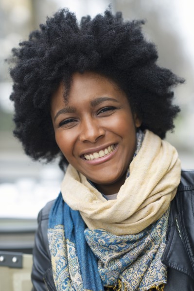 Smiling Black woman wearing scarves