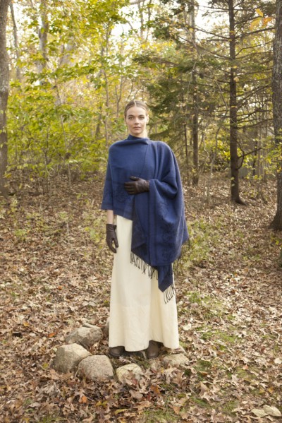 Woman wrapped in shawl in forest