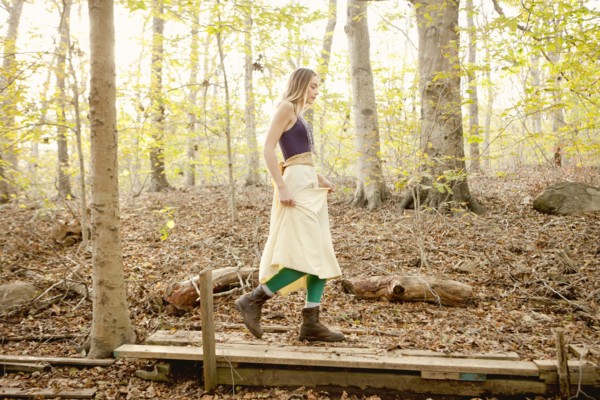 Woman walking on wooden walkway in forest