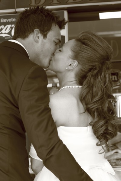 Caucasian bride and groom kissing at reception