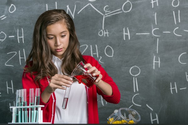 Hispanic student doing experiment in science class