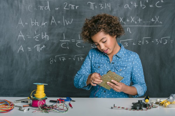 Mixed race student building vehicle in science class