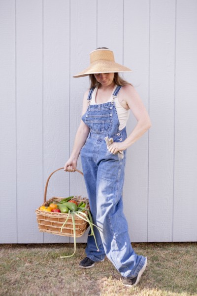 Mixed race farmer holding basket of vegetables