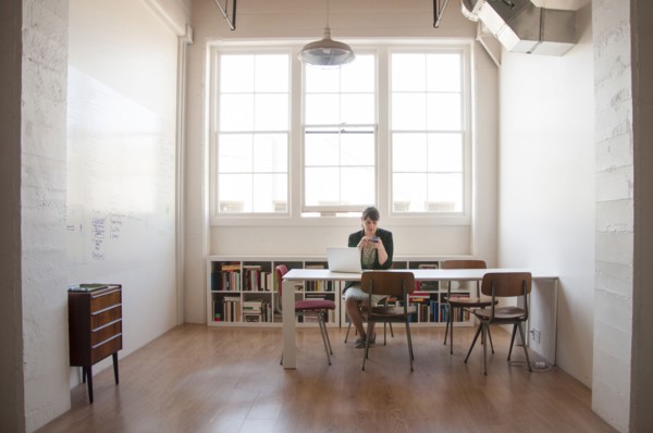 Caucasian businesswoman working on laptop in office
