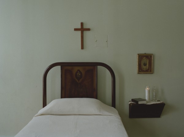 Crucifix over bed in simple bedroom