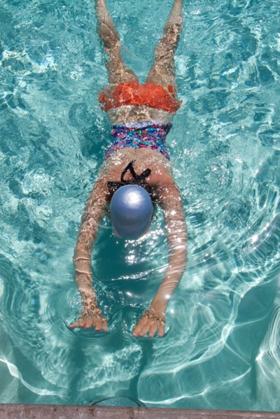High angle view of Caucasian woman swimming in pool
