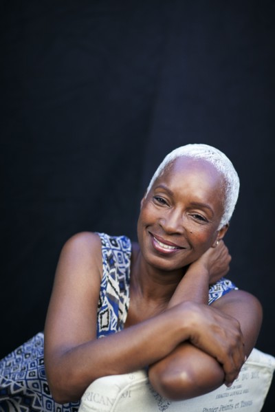 Smiling woman leaning on chair back