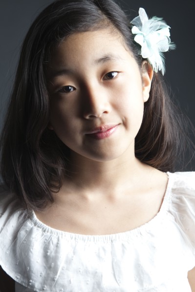 Smiling Asian girl wearing flower in her hair