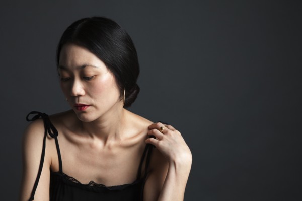 Disappointed Asian woman looking down