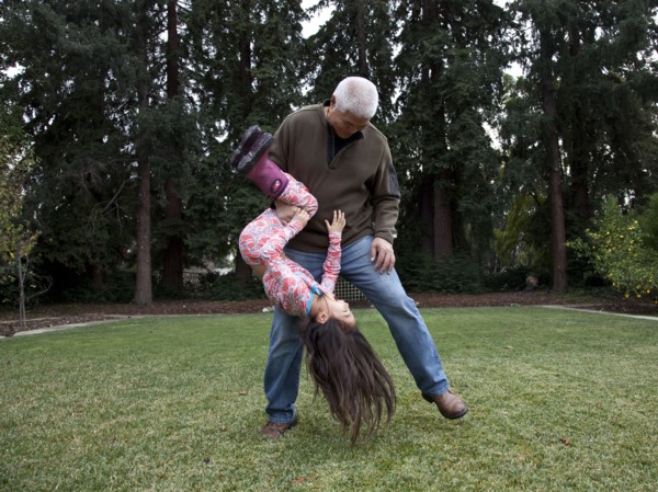 Father and daughter playing in backyard