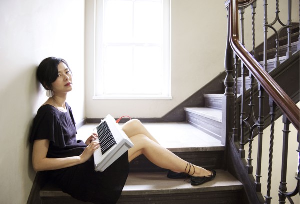 Taiwanese woman playing keyboard on staircase