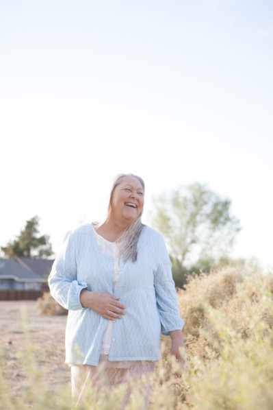 Caucasian woman laughing in backyard