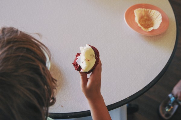 Teenage boy eating cupcake