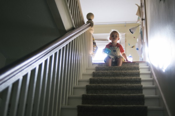 Boy playing at top of staircase