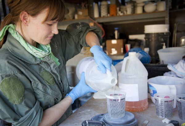 Entrepreneur pouring liquid in workshop