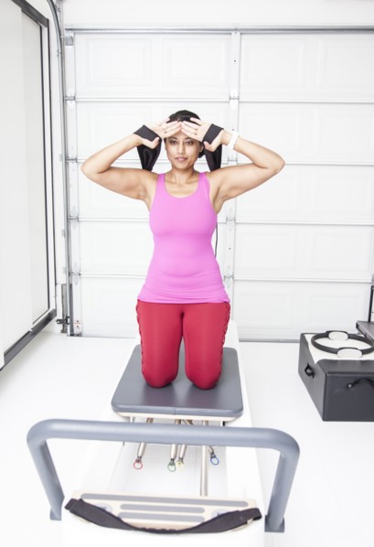 Asian woman using exercise machine in gymnasium