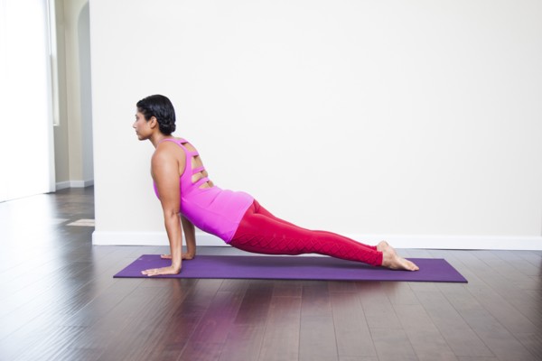 Asian woman practicing yoga in studio