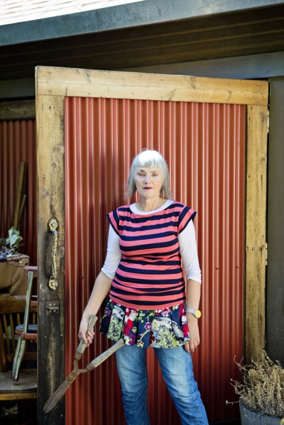 Older Caucasian woman holding shears in backyard