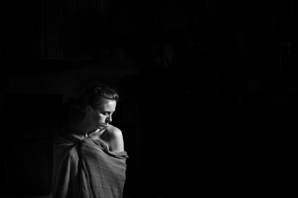 Caucasian woman wrapped in blanket