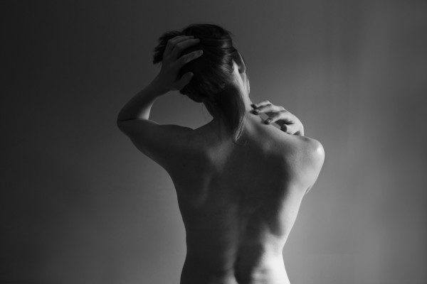 Muscular back of nude Caucasian woman